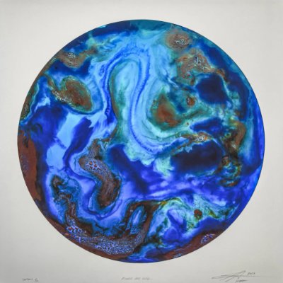 A round shape filled with swirling colors of blues, greens, and copper. It resembles Earth.